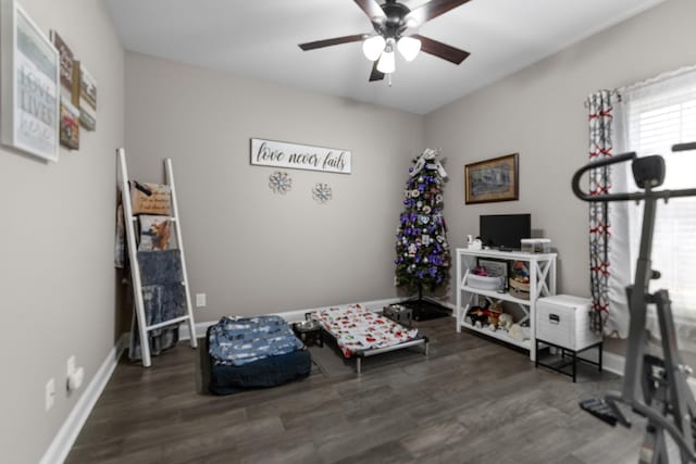 bedroom with a ceiling fan, baseboards, and wood finished floors