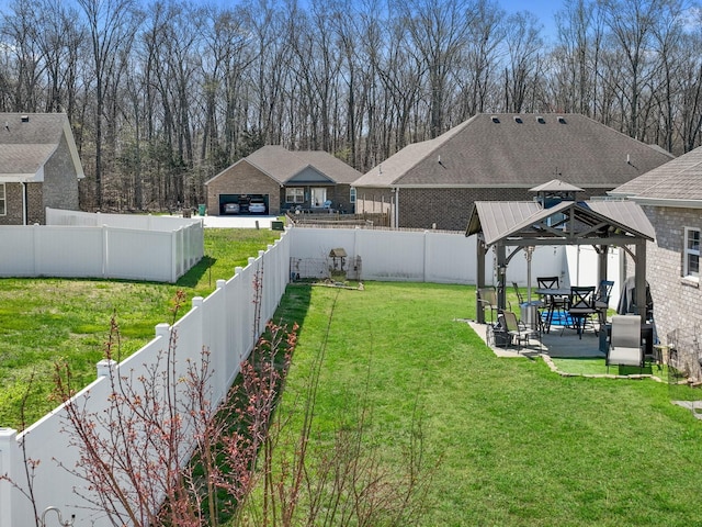 view of yard featuring a fenced backyard, a gazebo, and a patio area