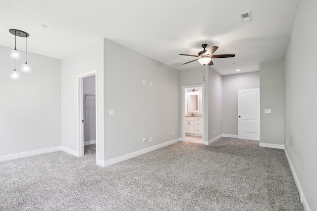 empty room with light colored carpet, ceiling fan, and baseboards