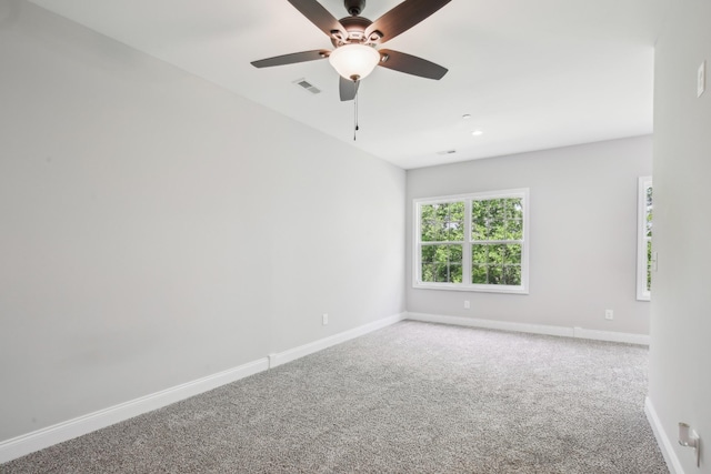 unfurnished room featuring carpet flooring, baseboards, and a ceiling fan