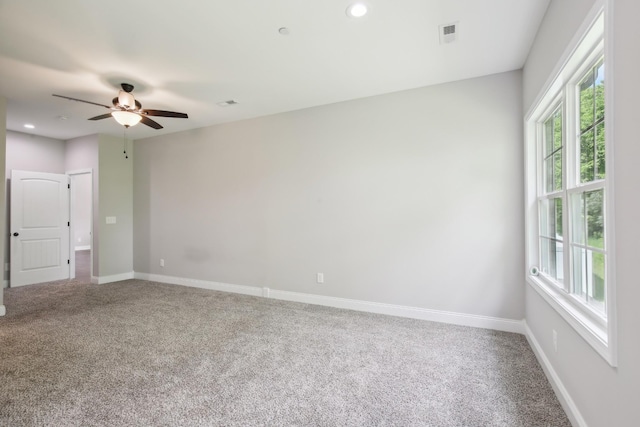 carpeted spare room featuring plenty of natural light, a ceiling fan, baseboards, and recessed lighting