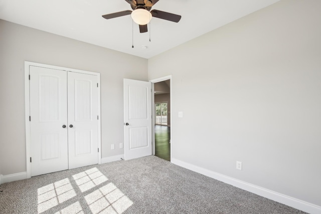 unfurnished bedroom with carpet floors, baseboards, a closet, and ceiling fan