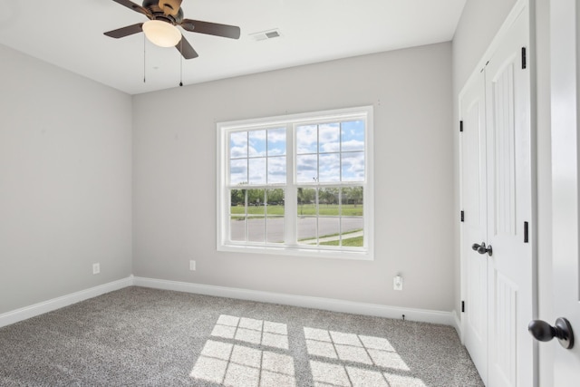 unfurnished bedroom with multiple windows, carpet flooring, and baseboards