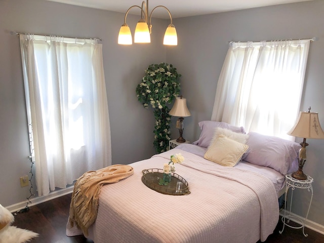 bedroom featuring baseboards and wood finished floors