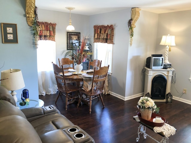 living area featuring baseboards and wood finished floors