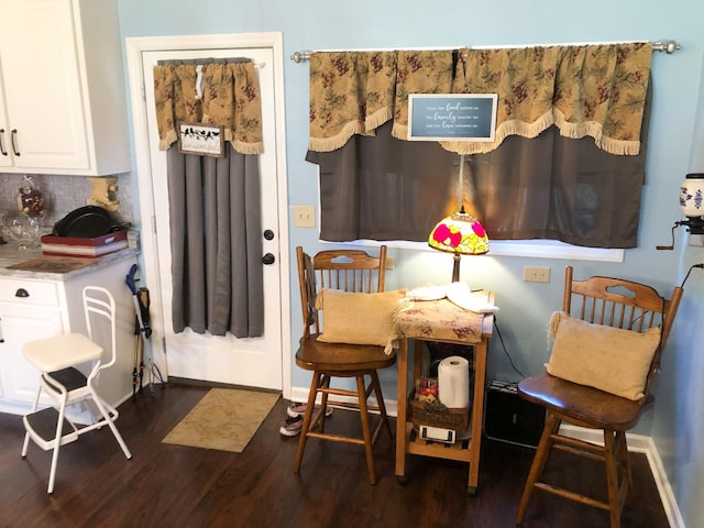 dining room with dark wood finished floors and baseboards