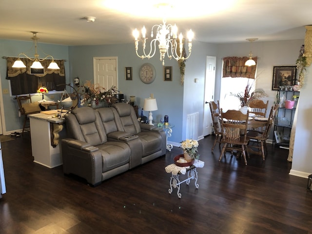 living area with dark wood-style flooring, a notable chandelier, baseboards, and visible vents