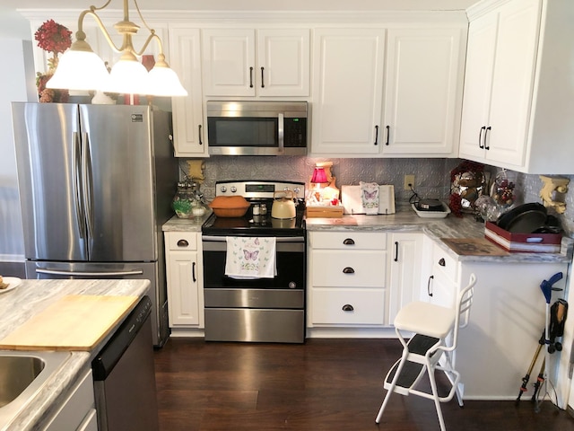 kitchen featuring decorative backsplash, dark wood-style flooring, light countertops, white cabinets, and stainless steel appliances