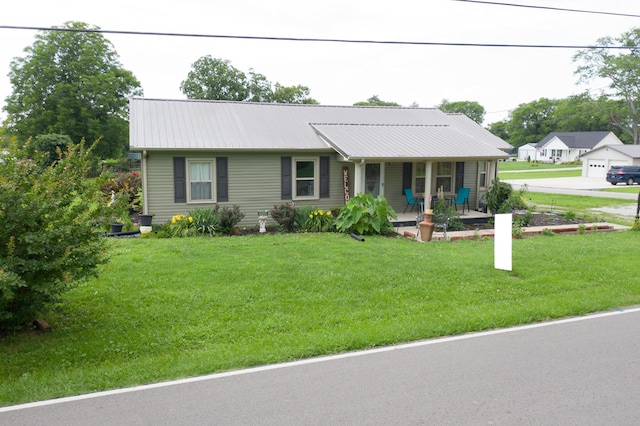 96 Liberty Rd, Winchester, TN 37398 - view of front of house with a porch, a front lawn, and a metal roof