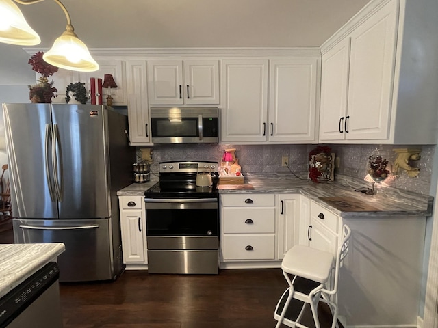 96 Liberty Rd, Winchester, TN 37398 - kitchen with appliances with stainless steel finishes, white cabinets, tasteful backsplash, and dark wood-type flooring