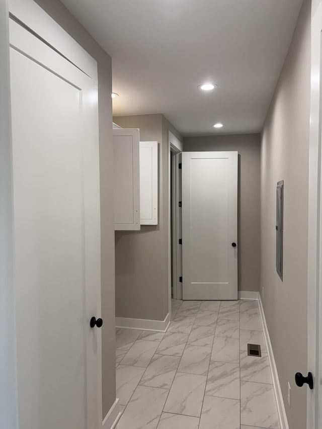 hall featuring recessed lighting, marble finish floor, and baseboards
