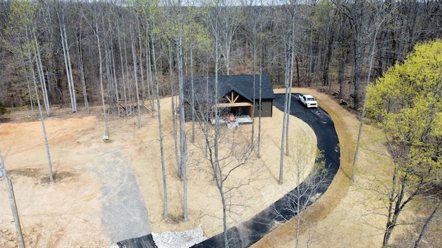 aerial view featuring a wooded view