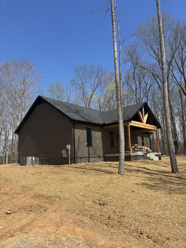 exterior space featuring a shingled roof