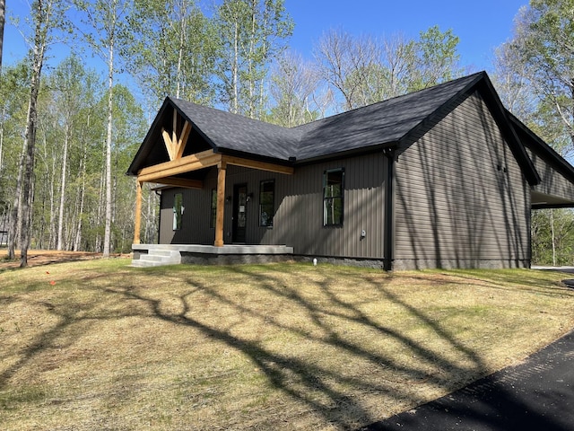exterior space with a shingled roof and covered porch