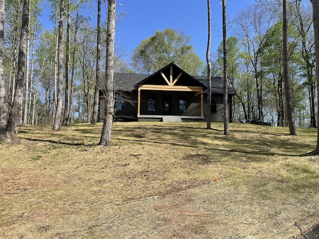 view of front facade with roof with shingles