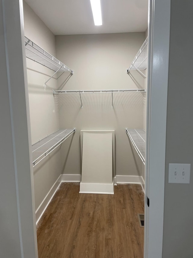 spacious closet with wood finished floors and visible vents