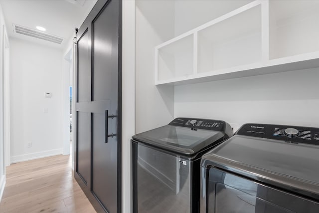 2510 Vaulx Ln, Nashville, TN 37204 - washroom featuring visible vents, baseboards, laundry area, light wood finished floors, and washing machine and dryer