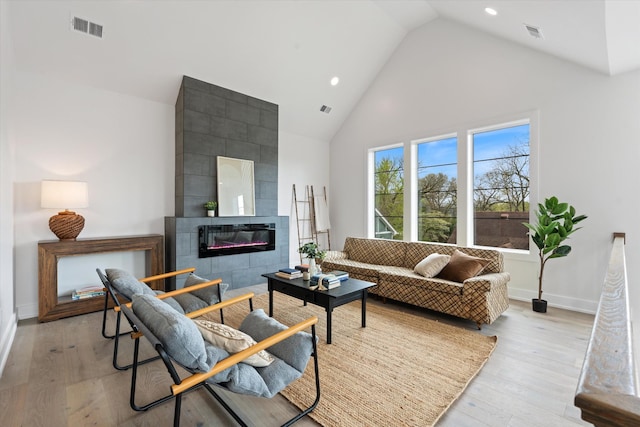 2510 Vaulx Ln, Nashville, TN 37204 - living room featuring high vaulted ceiling, light wood finished floors, and visible vents