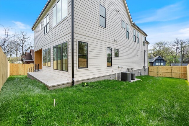 2510 Vaulx Ln, Nashville, TN 37204 - rear view of property featuring a patio, a fenced backyard, cooling unit, and a yard