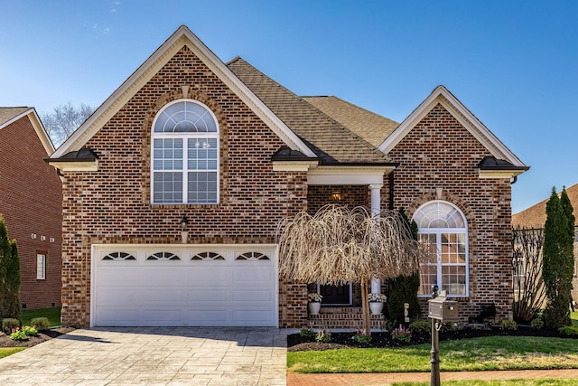 1145 Isaac Franklin Dr, Gallatin, TN 37066 - traditional-style home with driveway, a front lawn, brick siding, a garage, and a shingled roof