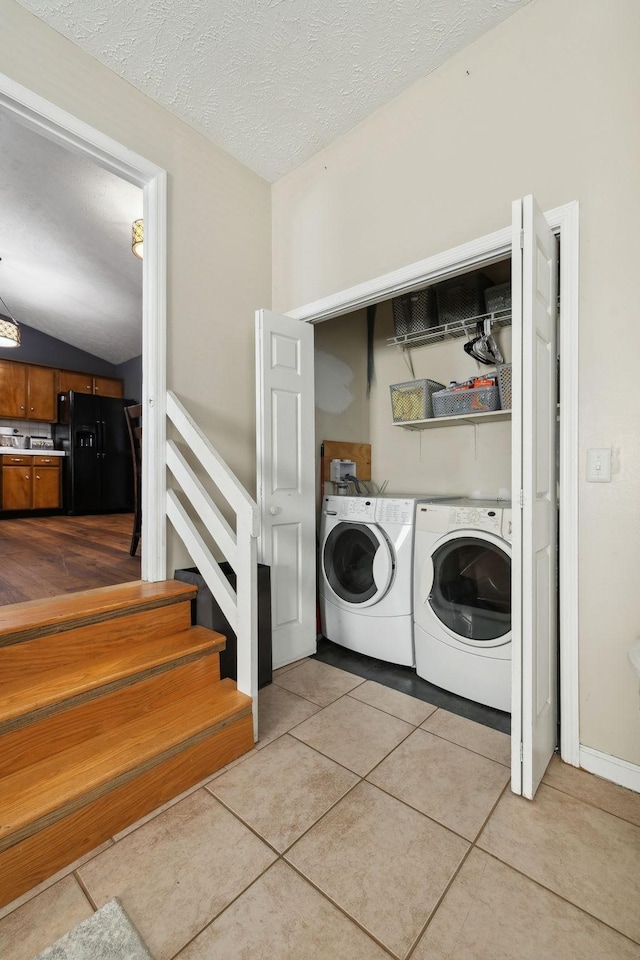 4825 Peppertree Dr, Antioch, TN 37013 - laundry room with a textured ceiling, washing machine and dryer, laundry area, and light tile patterned floors
