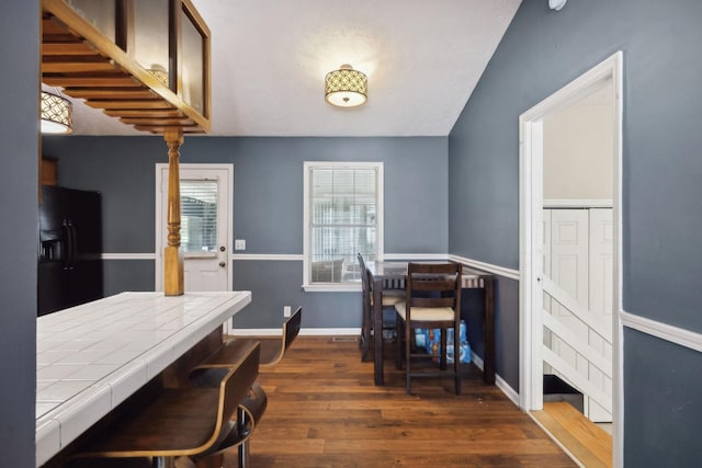 4825 Peppertree Dr, Antioch, TN 37013 - dining area featuring baseboards, dark wood-style floors, and vaulted ceiling