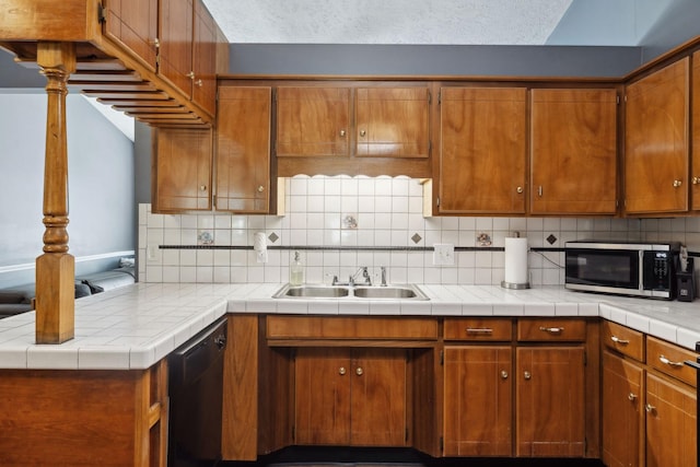 4825 Peppertree Dr, Antioch, TN 37013 - kitchen with decorative backsplash, stainless steel microwave, black dishwasher, a sink, and brown cabinetry