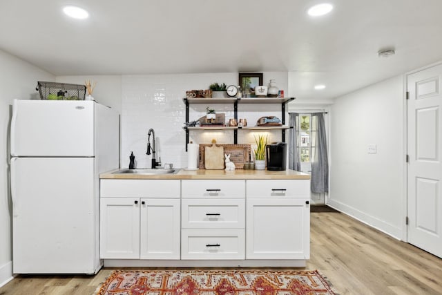 3617 Meadowbrook Ave, Nashville, TN 37205 - kitchen featuring freestanding refrigerator, recessed lighting, white cabinetry, a sink, and light wood finished floors