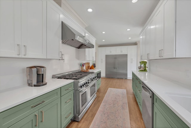 1237 Temple Ridge Dr, Nashville, TN 37221 - kitchen featuring green cabinets, white cabinets, high quality appliances, and wall chimney range hood
