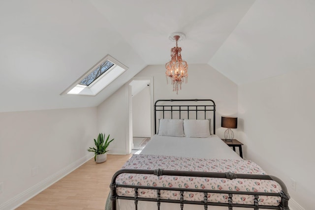 1237 Temple Ridge Dr, Nashville, TN 37221 - bedroom with light wood-style floors, baseboards, vaulted ceiling with skylight, and a chandelier