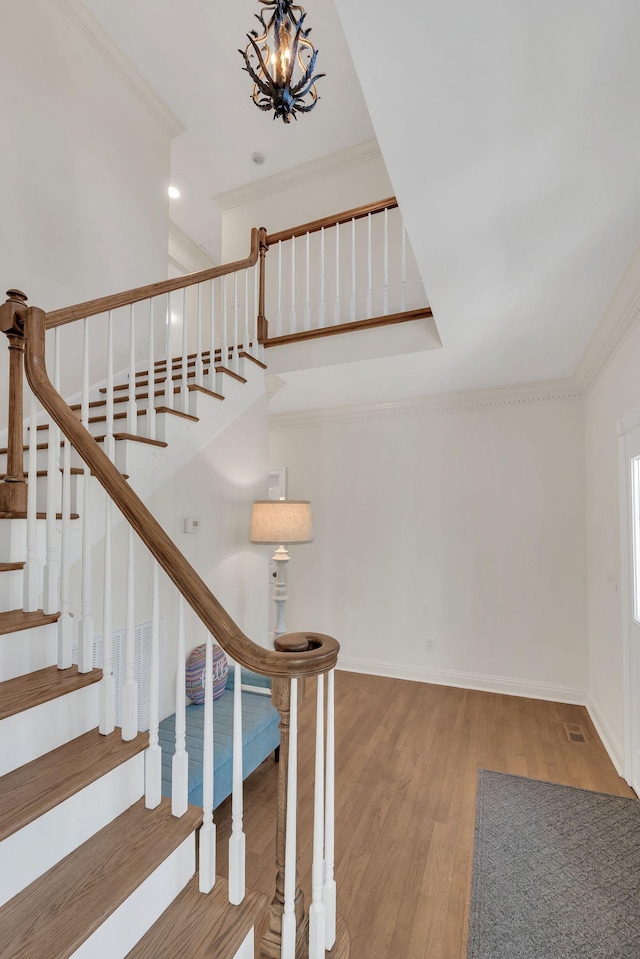 1237 Temple Ridge Dr, Nashville, TN 37221 - stairs featuring baseboards, wood finished floors, a chandelier, and crown molding