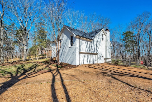 1237 Temple Ridge Dr, Nashville, TN 37221 - view of home's exterior featuring a chimney, fence, brick siding, and a garage