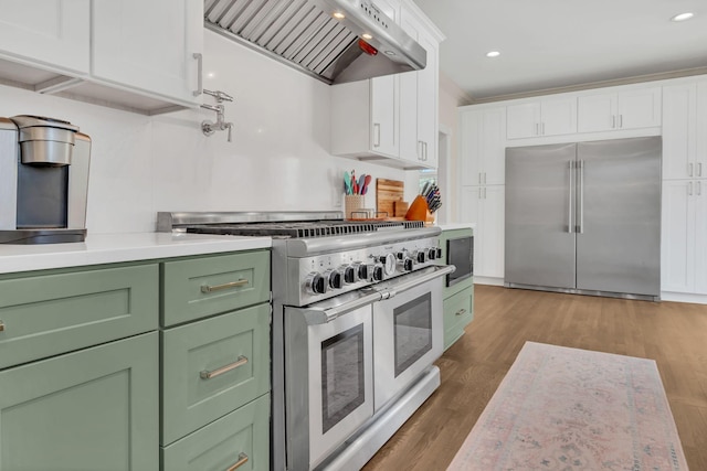 1237 Temple Ridge Dr, Nashville, TN 37221 - kitchen with green cabinets, white cabinetry, high quality appliances, and premium range hood