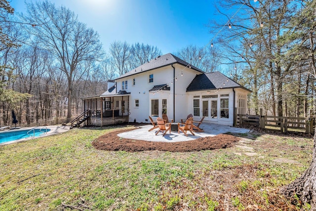 1237 Temple Ridge Dr, Nashville, TN 37221 - rear view of property featuring an outdoor pool, a sunroom, fence, a patio, and a lawn