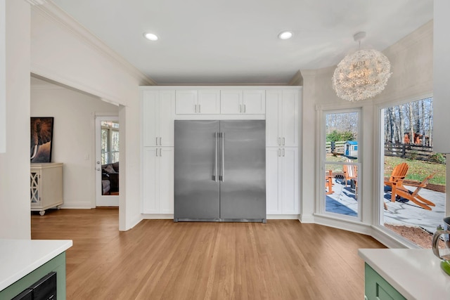 1237 Temple Ridge Dr, Nashville, TN 37221 - kitchen with built in fridge, light countertops, light wood-style flooring, and white cabinets