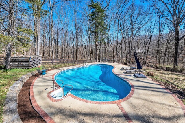 1237 Temple Ridge Dr, Nashville, TN 37221 - outdoor pool featuring a fenced backyard, a forest view, and a patio