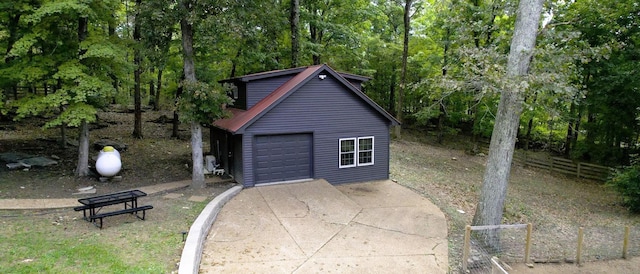2235 Rock Springs Rd, Columbia, TN 38401 - garage with fence, a forest view, and concrete driveway