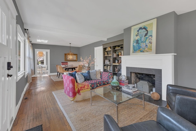 3814 Central Ave, Nashville, TN 37205 - living room with a brick fireplace, baseboards, and wood-type flooring