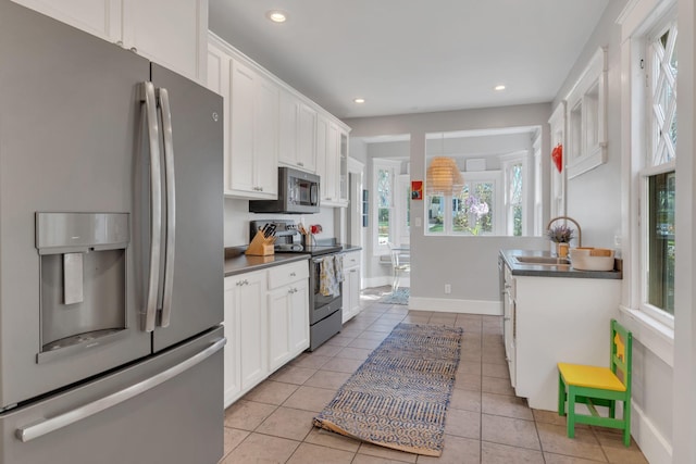 3814 Central Ave, Nashville, TN 37205 - kitchen featuring white cabinetry, dark countertops, appliances with stainless steel finishes, and light tile patterned floors