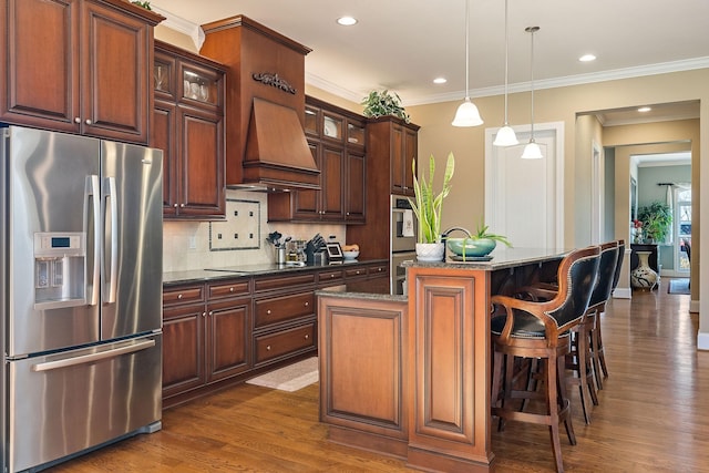 kitchen with appliances with stainless steel finishes, glass insert cabinets, an island with sink, custom range hood, and dark wood-style floors