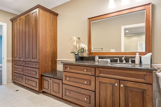 bathroom featuring ornamental molding and vanity
