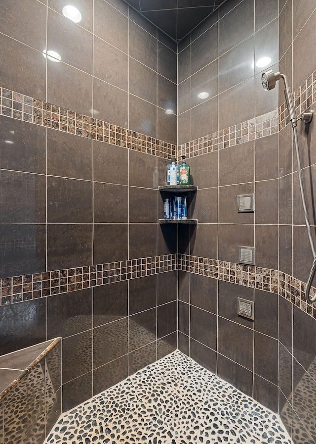 full bath featuring a tile shower