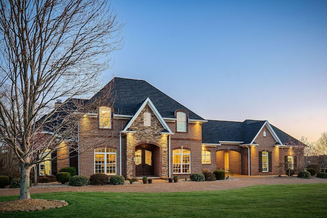 view of front of property with brick siding and a front yard