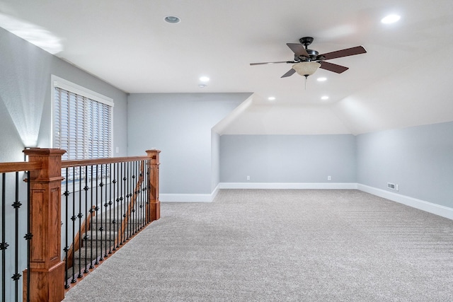 additional living space with carpet, baseboards, lofted ceiling, and ceiling fan