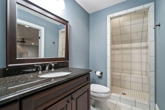 full bath with toilet, vanity, and a tile shower
