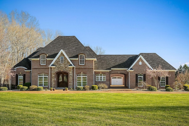 view of front of property with brick siding, a front lawn, and roof with shingles