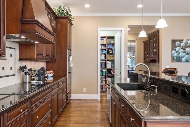 kitchen featuring crown molding, a sink, black electric stovetop, custom exhaust hood, and dark wood-style flooring