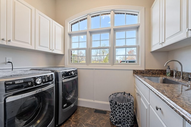 clothes washing area featuring washer and clothes dryer, a sink, marble finish floor, visible vents, and cabinet space