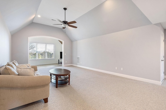 living room with a ceiling fan, light carpet, baseboards, and vaulted ceiling