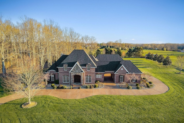 view of front of house with stone siding and a front yard